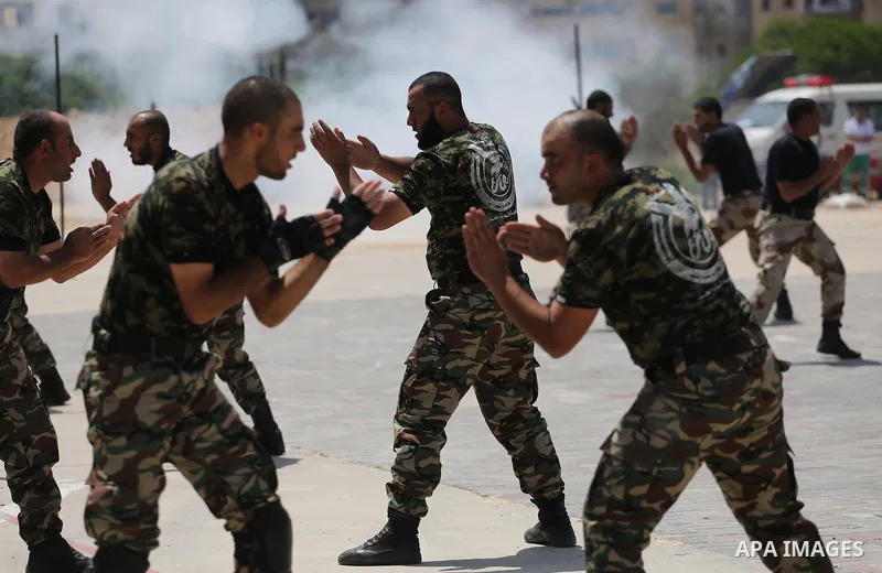 Member of Palestinian security forces display their skills during a military graduation ceremony in Gaza City June 2, 2016. Photo by Mohammed Asad