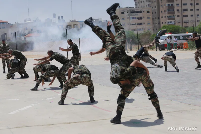 Member of Palestinian security forces display their skills during a military graduation ceremony in Gaza City June 2, 2016. Photo by Mohammed Asad