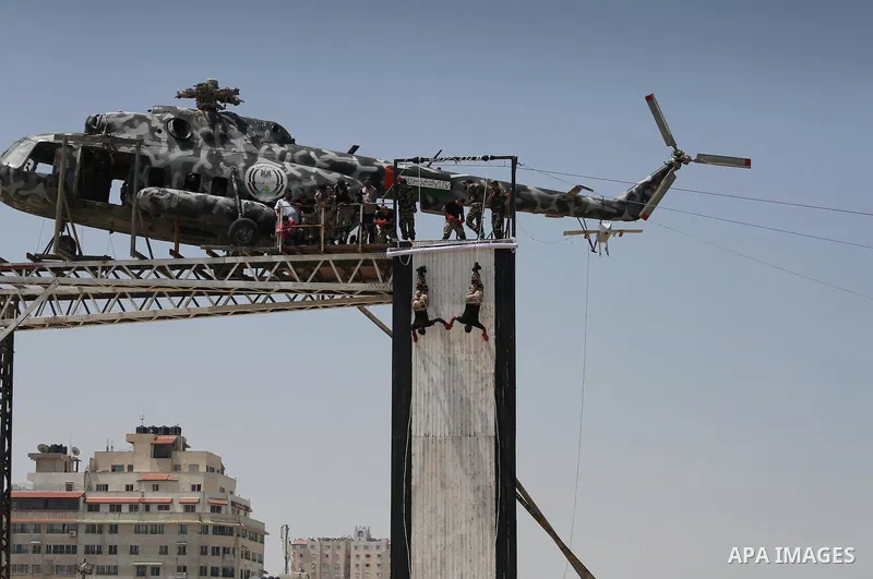 Member of Palestinian security forces display their skills during a military graduation ceremony in Gaza City June 2, 2016. Photo by Mohammed Asad