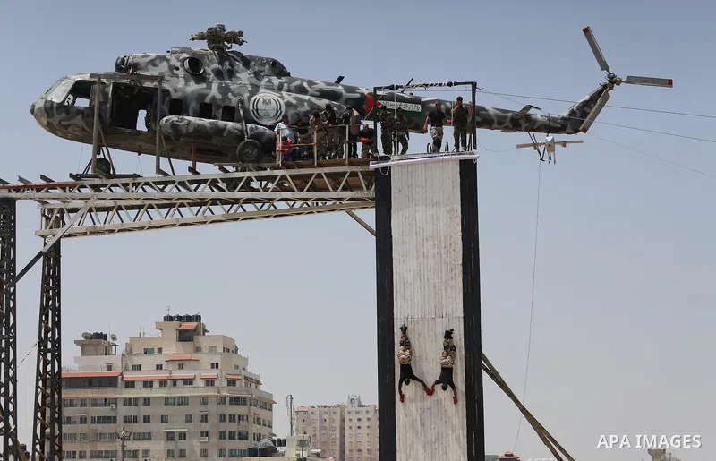 Member of Palestinian security forces display their skills during a military graduation ceremony in Gaza City June 2, 2016. Photo by Mohammed Asad