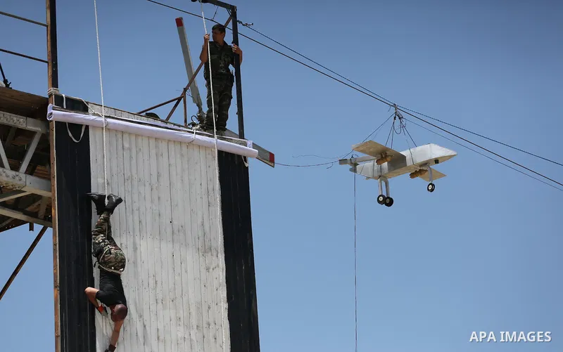 Member of Palestinian security forces display their skills during a military graduation ceremony in Gaza City June 2, 2016. Photo by Mohammed Asad