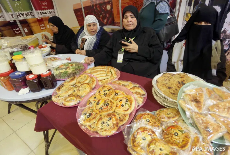 Palestinians take part in an exhibition of the Palestinian food, in Gaza city, on June 2, 2016. Photo by Mohammed Asad