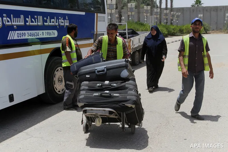Palestinians wait for travel permits to cross into Egypt through the Rafah border crossing after it was opened for four days by Egyptian authorities, in the southern Gaza Strip June 02, 2016. Photo by Abed Rahim Khatib