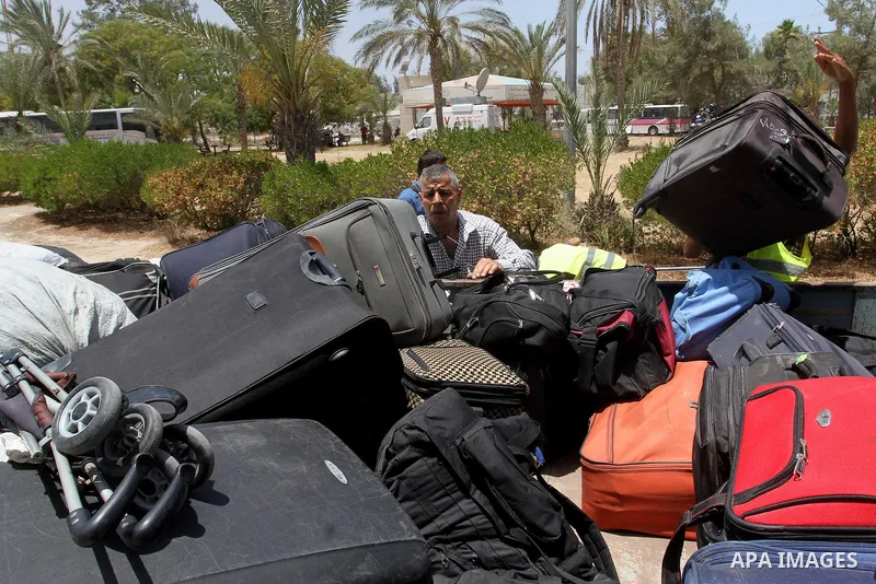 Palestinians wait for travel permits to cross into Egypt through the Rafah border crossing after it was opened for four days by Egyptian authorities, in the southern Gaza Strip June 02, 2016. Photo by Abed Rahim Khatib