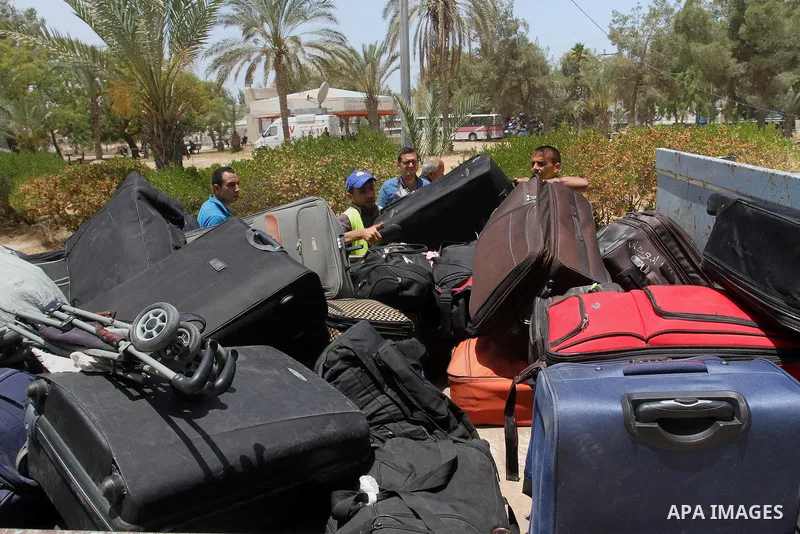 Palestinians wait for travel permits to cross into Egypt through the Rafah border crossing after it was opened for four days by Egyptian authorities, in the southern Gaza Strip June 02, 2016. Photo by Abed Rahim Khatib