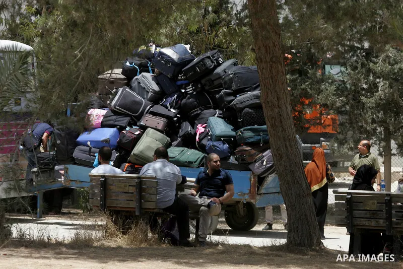 Palestinians wait for travel permits to cross into Egypt through the Rafah border crossing after it was opened for four days by Egyptian authorities, in the southern Gaza Strip June 02, 2016. Photo by Abed Rahim Khatib