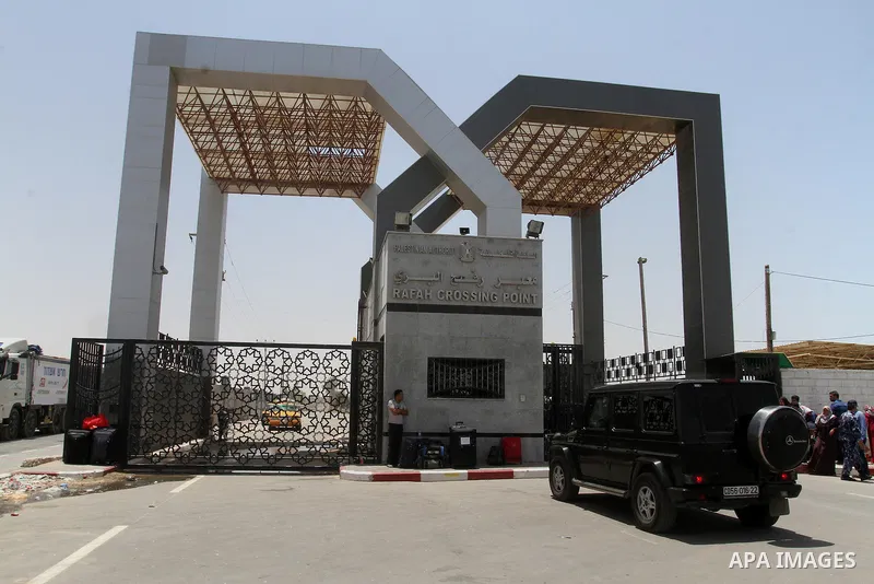 Palestinians wait for travel permits to cross into Egypt through the Rafah border crossing after it was opened for four days by Egyptian authorities, in the southern Gaza Strip June 02, 2016. Photo by Abed Rahim Khatib