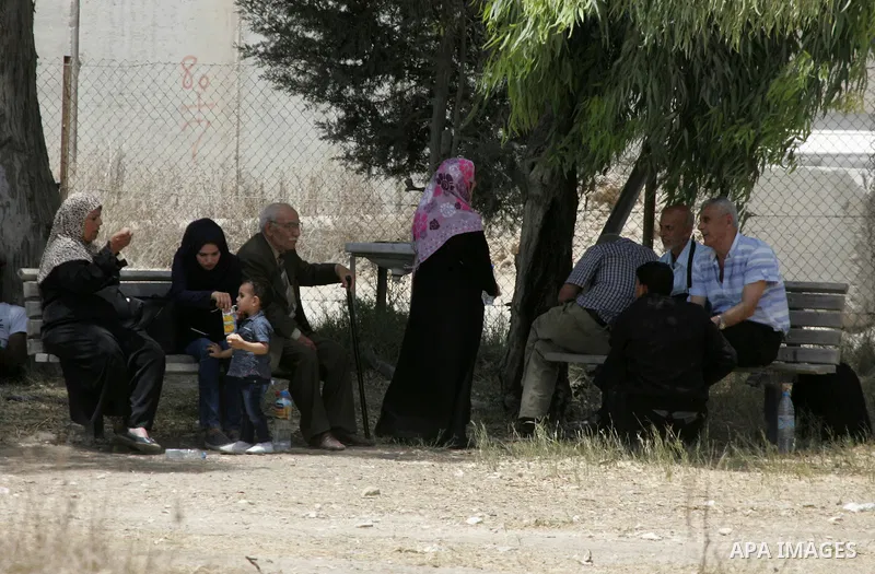 Palestinians wait for travel permits to cross into Egypt through the Rafah border crossing after it was opened for four days by Egyptian authorities, in the southern Gaza Strip June 02, 2016. Photo by Abed Rahim Khatib