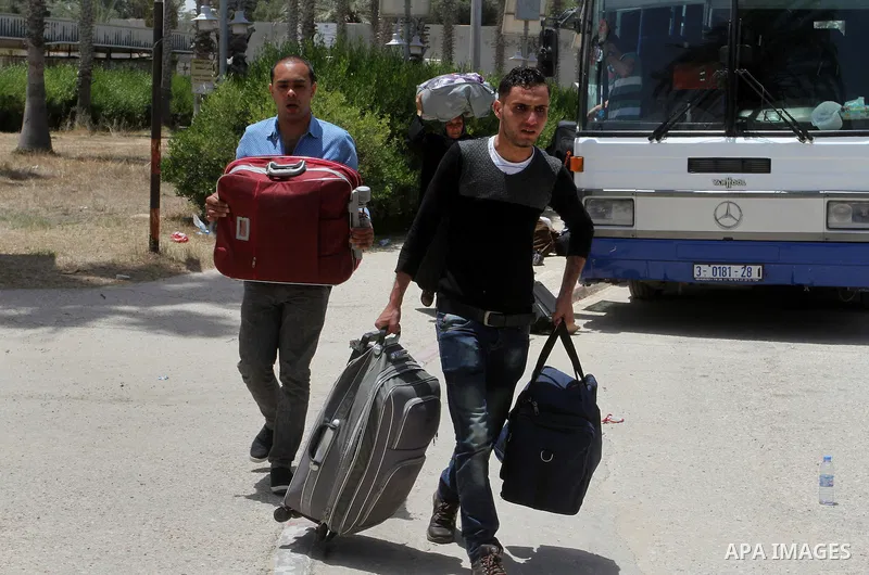 Palestinians wait for travel permits to cross into Egypt through the Rafah border crossing after it was opened for four days by Egyptian authorities, in the southern Gaza Strip June 02, 2016. Photo by Abed Rahim Khatib
