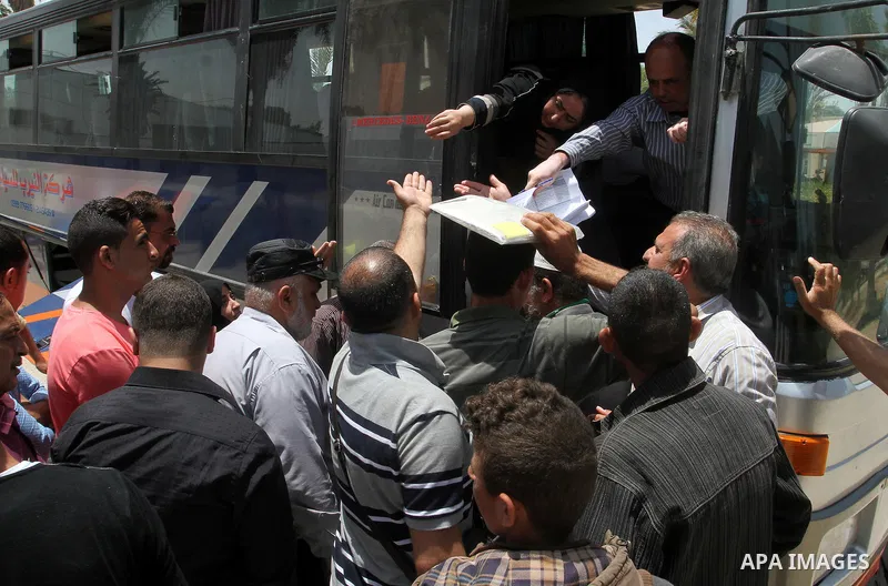 Palestinians wait for travel permits to cross into Egypt through the Rafah border crossing after it was opened for four days by Egyptian authorities, in the southern Gaza Strip June 02, 2016. Photo by Abed Rahim Khatib