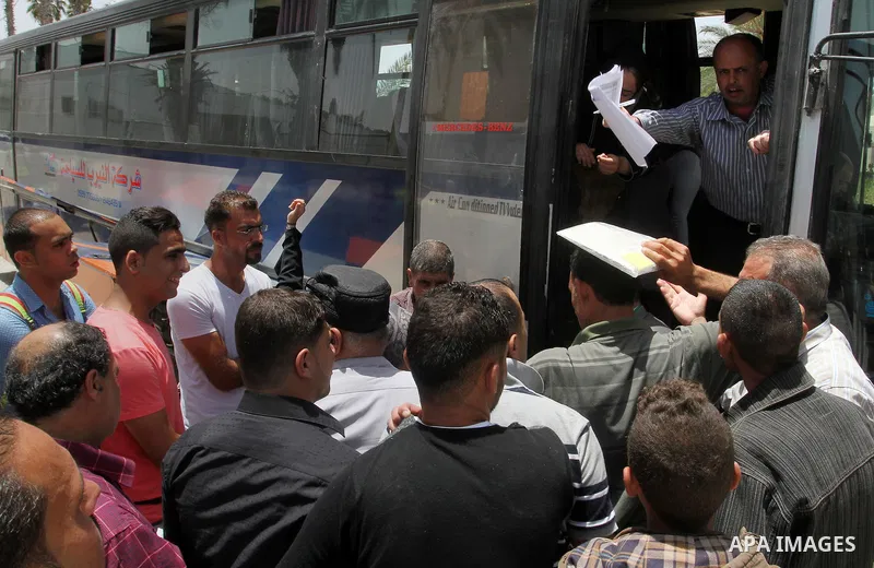 Palestinians wait for travel permits to cross into Egypt through the Rafah border crossing after it was opened for four days by Egyptian authorities, in the southern Gaza Strip June 02, 2016. Photo by Abed Rahim Khatib