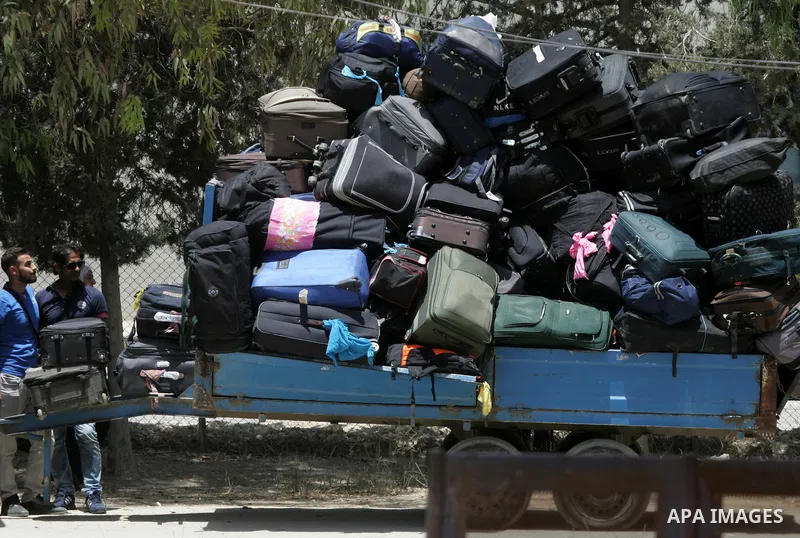 Palestinians wait for travel permits to cross into Egypt through the Rafah border crossing after it was opened for four days by Egyptian authorities, in the southern Gaza Strip June 02, 2016. Photo by Abed Rahim Khatib