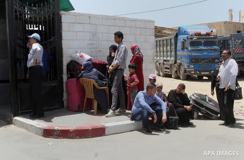 Palestinians wait for travel permits to cross into Egypt through the Rafah border crossing after it was opened for four days by Egyptian authorities, in the southern Gaza Strip June 02, 2016. Photo by Abed Rahim Khatib