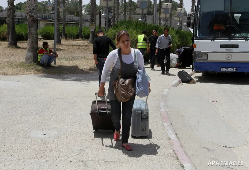 Palestinians wait for travel permits to cross into Egypt through the Rafah border crossing after it was opened for four days by Egyptian authorities, in the southern Gaza Strip June 02, 2016. Photo by Abed Rahim Khatib