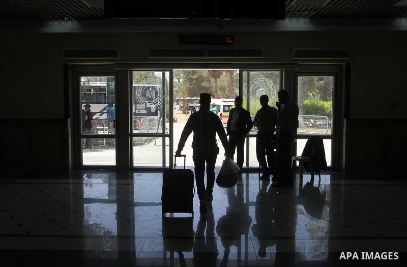 Palestinians wait for travel permits to cross into Egypt through the Rafah border crossing after it was opened for four days by Egyptian authorities, in the southern Gaza Strip June 02, 2016. Photo by Abed Rahim Khatib