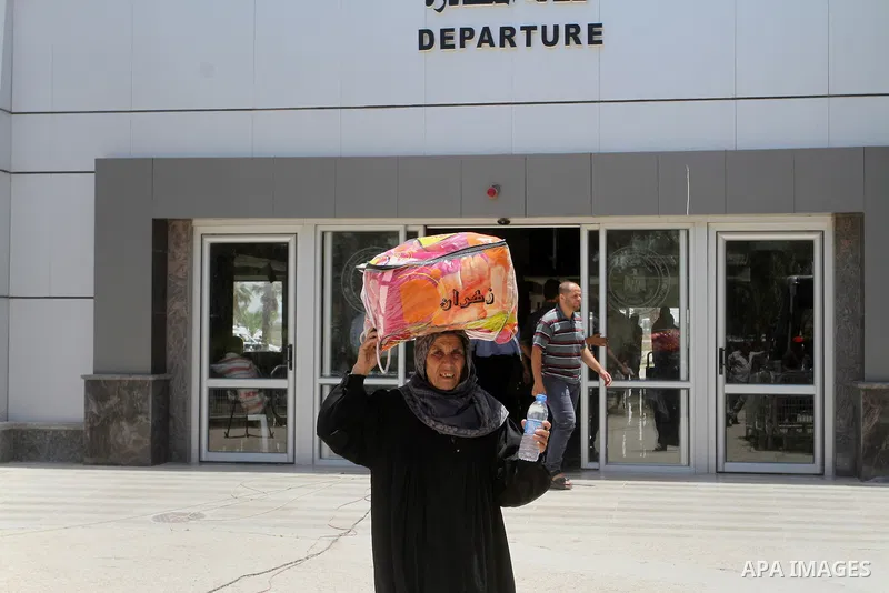 Palestinians wait for travel permits to cross into Egypt through the Rafah border crossing after it was opened for four days by Egyptian authorities, in the southern Gaza Strip June 02, 2016. Photo by Abed Rahim Khatib