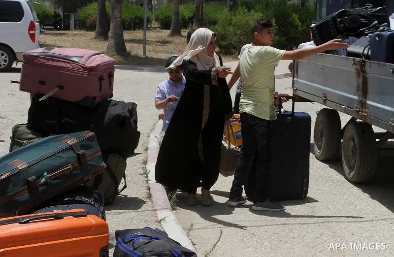 Palestinians wait for travel permits to cross into Egypt through the Rafah border crossing after it was opened for four days by Egyptian authorities, in the southern Gaza Strip June 02, 2016. Photo by Abed Rahim Khatib