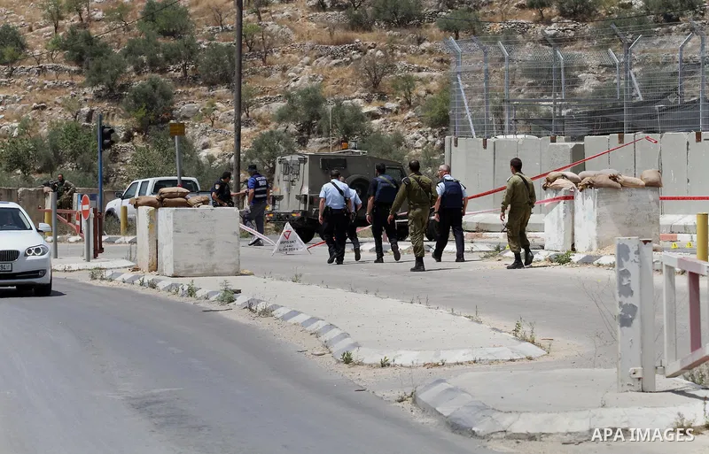 Israeli security forces inspect the scene of a stabbing attack at a checkpoint near the West Bank city of Tulkarem on June 2, 2016. A female Palestinian tried to stab an Israeli soldier near of Tulkarem and was shot dead...