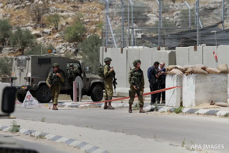 Israeli security forces inspect the scene of a stabbing attack at a checkpoint near the West Bank city of Tulkarem on June 2, 2016. A female Palestinian tried to stab an Israeli soldier near of Tulkarem and was shot dead...