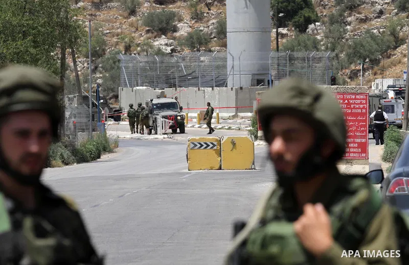 Israeli security forces inspect the scene of a stabbing attack at a checkpoint near the West Bank city of Tulkarem on June 2, 2016. A female Palestinian tried to stab an Israeli soldier near of Tulkarem and was shot dead...
