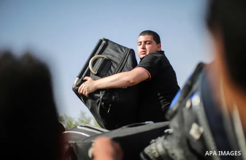 Palestinians wait for travel permits to cross into Egypt through the Rafah border crossing after it was opened for four days by Egyptian authorities, in the southern Gaza Strip June 02, 2016. Photo by Mohammed Dahman