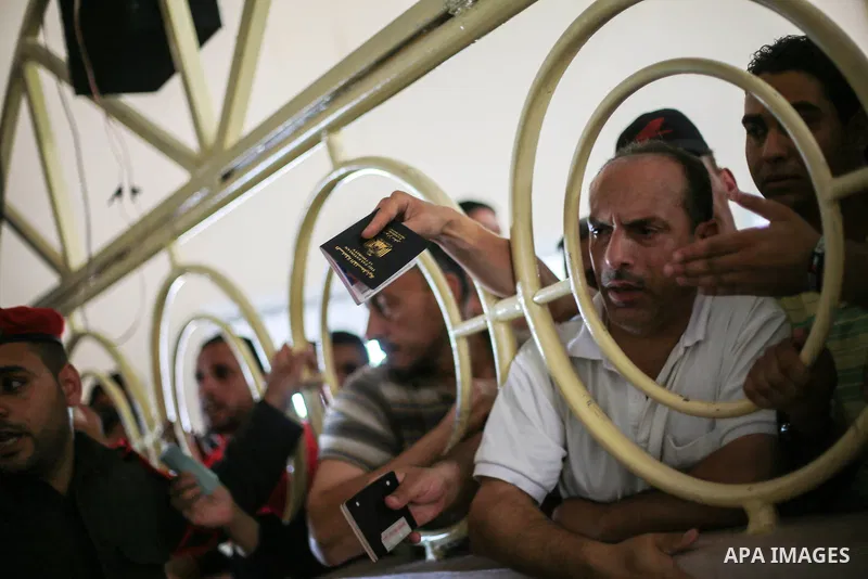 Palestinians wait for travel permits to cross into Egypt through the Rafah border crossing after it was opened for four days by Egyptian authorities, in the southern Gaza Strip June 02, 2016. Photo by Mohammed Dahman