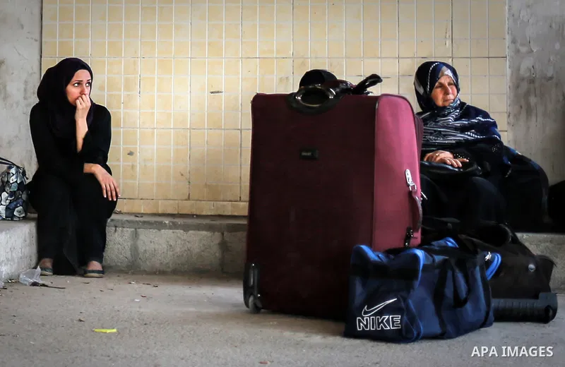 Palestinians wait for travel permits to cross into Egypt through the Rafah border crossing after it was opened for four days by Egyptian authorities, in the southern Gaza Strip June 02, 2016. Photo by Mohammed Dahman