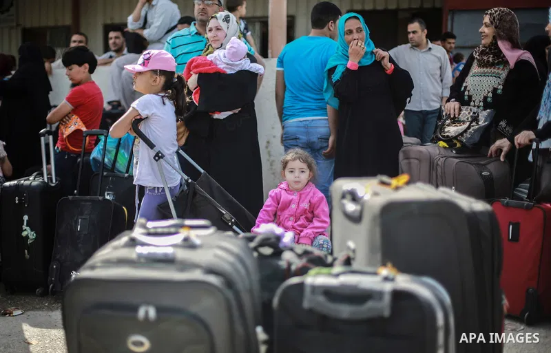 Palestinians wait for travel permits to cross into Egypt through the Rafah border crossing after it was opened for four days by Egyptian authorities, in the southern Gaza Strip June 02, 2016. Photo by Mohammed Dahman