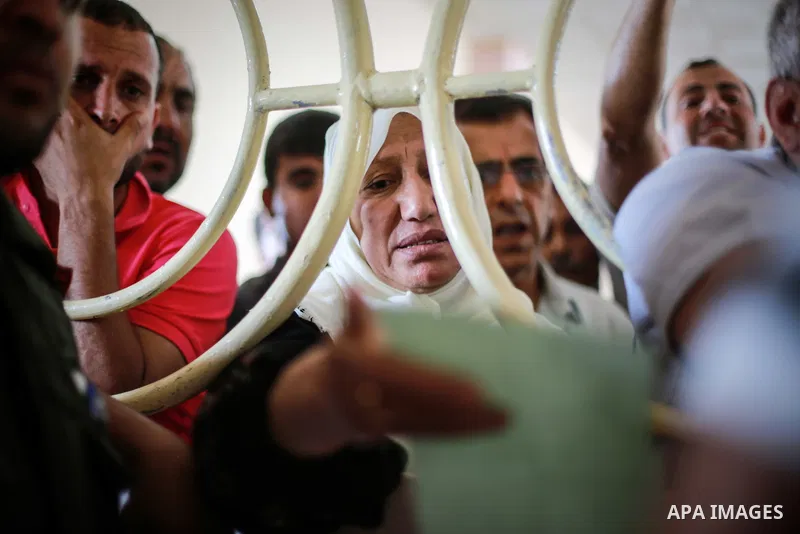 Palestinians wait for travel permits to cross into Egypt through the Rafah border crossing after it was opened for four days by Egyptian authorities, in the southern Gaza Strip June 02, 2016. Photo by Mohammed Dahman