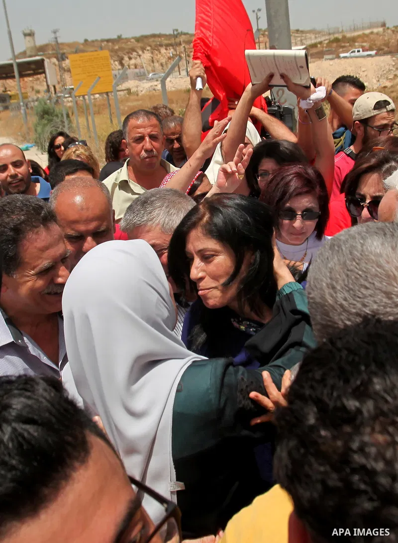 Prominent Palestinian lawmaker Khalida Jarrar hugs a supporter at the Jubara checkpoint near the northern West Bank city of Tulkarem, following her release from an Israeli jail on June 3, 2016, after serving a 15-month s...