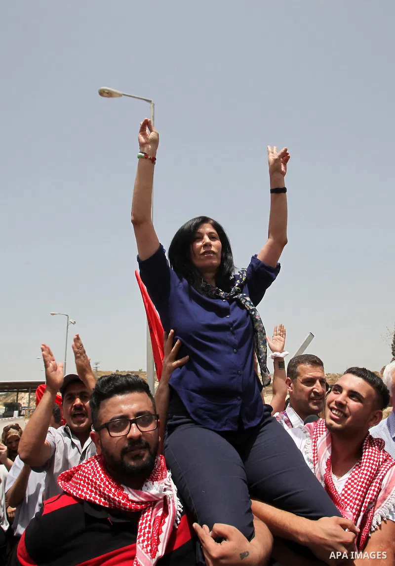 Prominent Palestinian lawmaker Khalida Jarrar is lifted up by supporters at the Jubara checkpoint near the northern West Bank city of Tulkarem, following her release from an Israeli jail on June 3, 2016, after serving a...