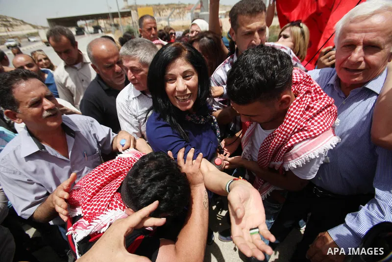Prominent Palestinian lawmaker Khalida Jarrar hugs a supporter at the Jubara checkpoint near the northern West Bank city of Tulkarem, following her release from an Israeli jail on June 3, 2016, after serving a 15-month s...
