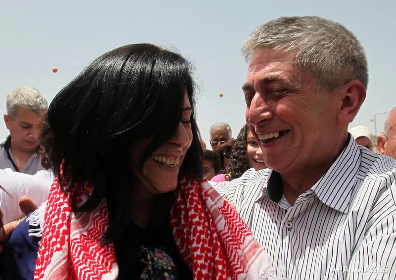 Prominent Palestinian lawmaker Khalida Jarrar hugs her husband at the Jubara checkpoint near the northern West Bank city of Tulkarem, following her release from an Israeli jail on June 3, 2016, after serving a 15-month s...