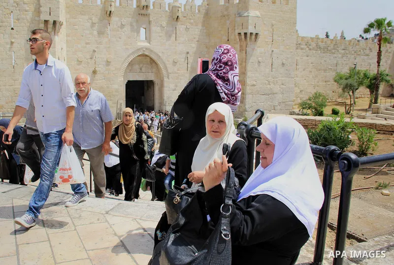 Palestinian Muslim worshipers walk in front of the Damascus gate following Friday prayers at al-Aqsa mosque,Islam's third holiest site, in Jerusalem's Old city on June 03, 2016 on the last Friday before the Islamic holy...