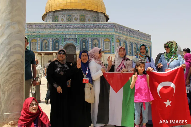 Palestinian women hold a national flag and Turkish flag in front of Dome of the Rock following Friday prayers at al-Aqsa mosque,Islam's third holiest site, in Jerusalem's Old city on June 03, 2016 on the last Friday befo...