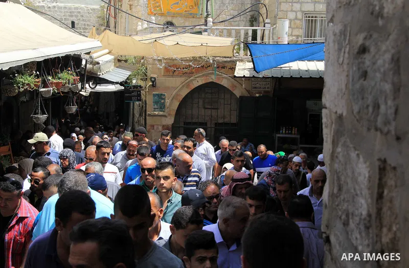 Palestinians walk at a market following Friday prayers at al-Aqsa mosque,Islam's third holiest site, in Jerusalem's Old city on June 03, 2016 on the last Friday before the Islamic holy month of Ramadan. Photo by Mahfouz...
