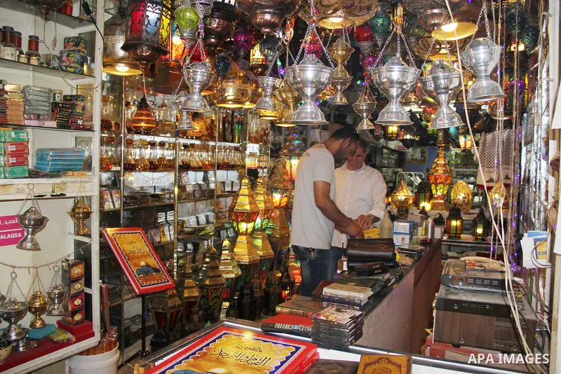 A Palestinian vendor displays a traditional lantern known in Arabic as "Fanous" in a market in Jerusalem's Old city on June 03, 2016. Photo by Mahfouz Abu Turk