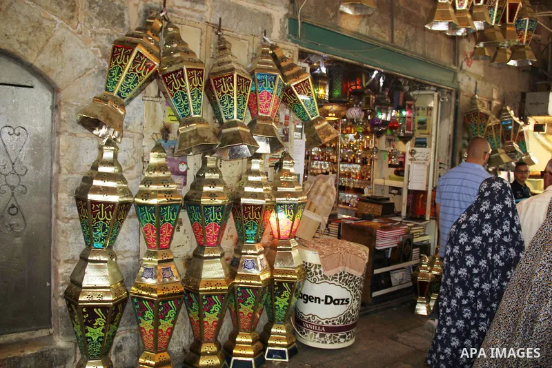 A Palestinian vendor displays a traditional lantern known in Arabic as "Fanous" in a market in Jerusalem's Old city on June 03, 2016. Photo by Mahfouz Abu Turk