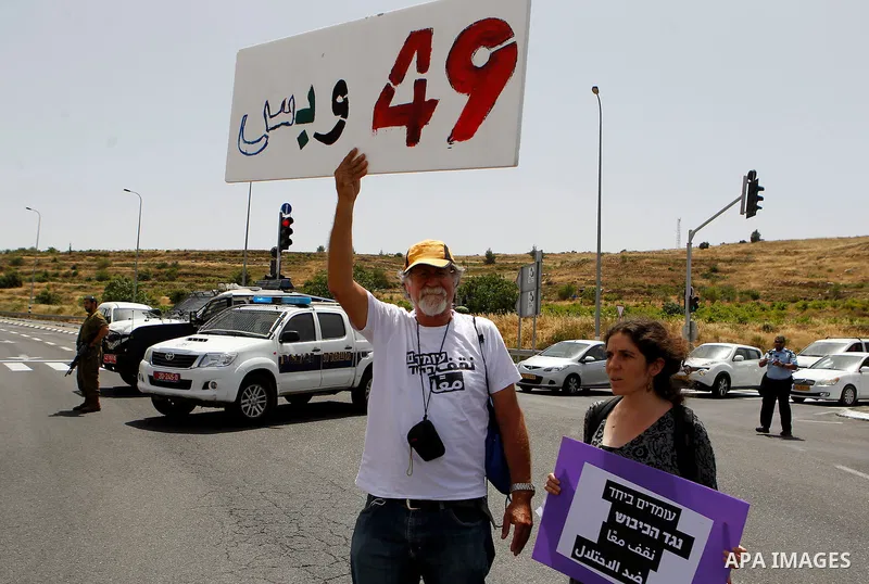Palestinian and Israeli activists take part in a demonstration in support of peace near the West Bank city of Bethlehem June 3, 2016. Photo by Wisam Hashlamoun