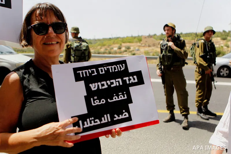 Palestinian and Israeli activists take part in a demonstration in support of peace near the West Bank city of Bethlehem June 3, 2016. Photo by Wisam Hashlamoun