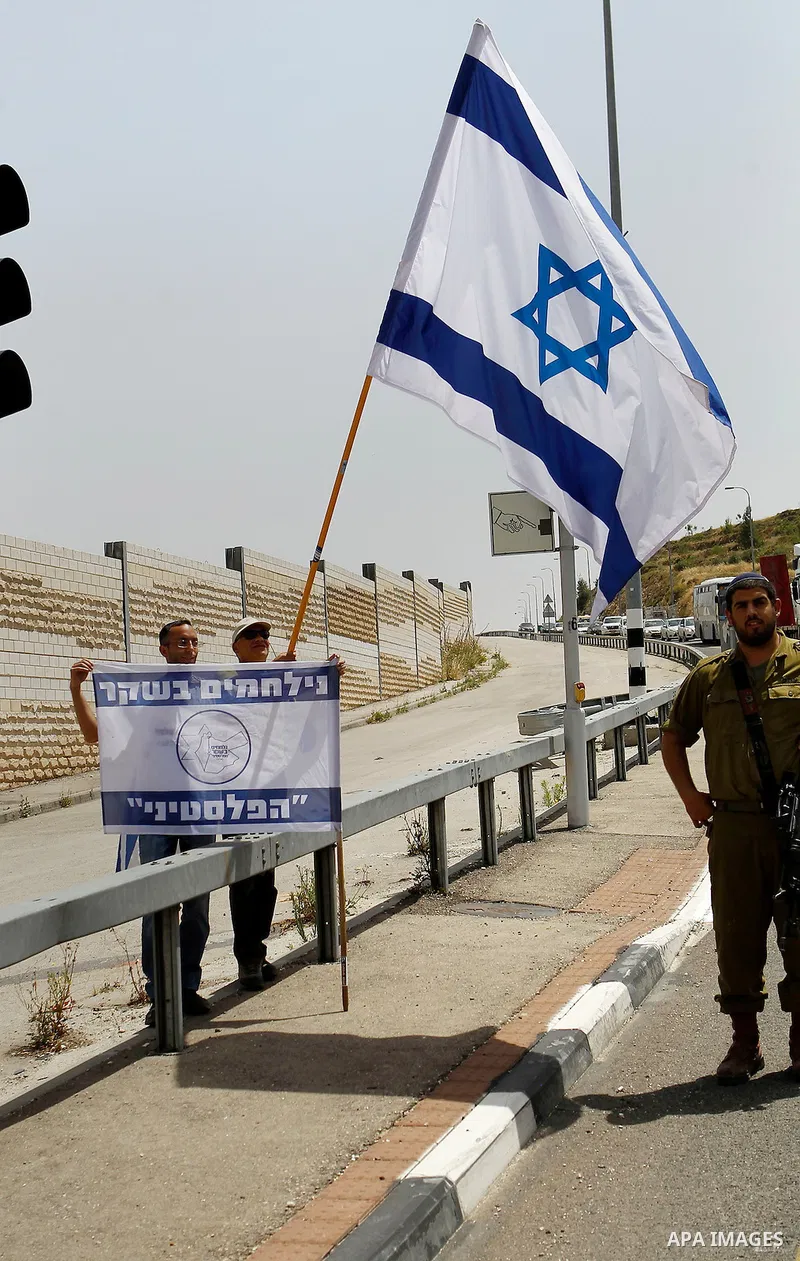 Palestinian and Israeli activists take part in a demonstration in support of peace near the West Bank city of Bethlehem June 3, 2016. Photo by Wisam Hashlamoun