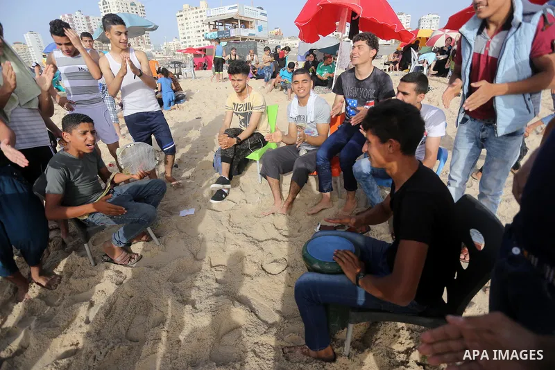 Palestinians enjoy a day at the beach of the Mediterranean sea on the coast of Gaza city, on June 03, 2016 on the last Friday before the Islamic holy month of Ramadan. Photo by Mohammed Asad