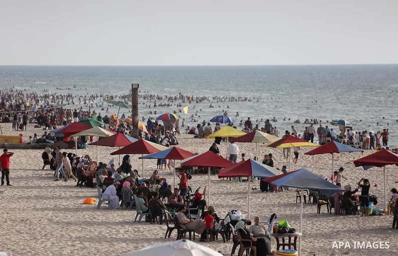 Palestinians enjoy a day at the beach of the Mediterranean sea on the coast of Gaza city, on June 03, 2016 on the last Friday before the Islamic holy month of Ramadan. Photo by Mohammed Asad