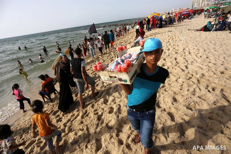 Palestinians enjoy a day at the beach of the Mediterranean sea on the coast of Gaza city, on June 03, 2016 on the last Friday before the Islamic holy month of Ramadan. Photo by Mohammed Asad