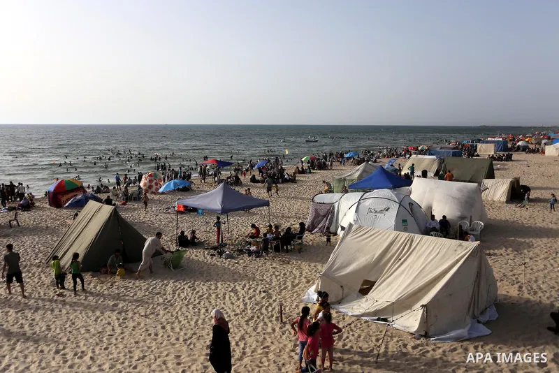 Palestinians enjoy a day at the beach of the Mediterranean sea on the coast of Gaza city, on June 03, 2016 on the last Friday before the Islamic holy month of Ramadan. Photo by Mohammed Asad