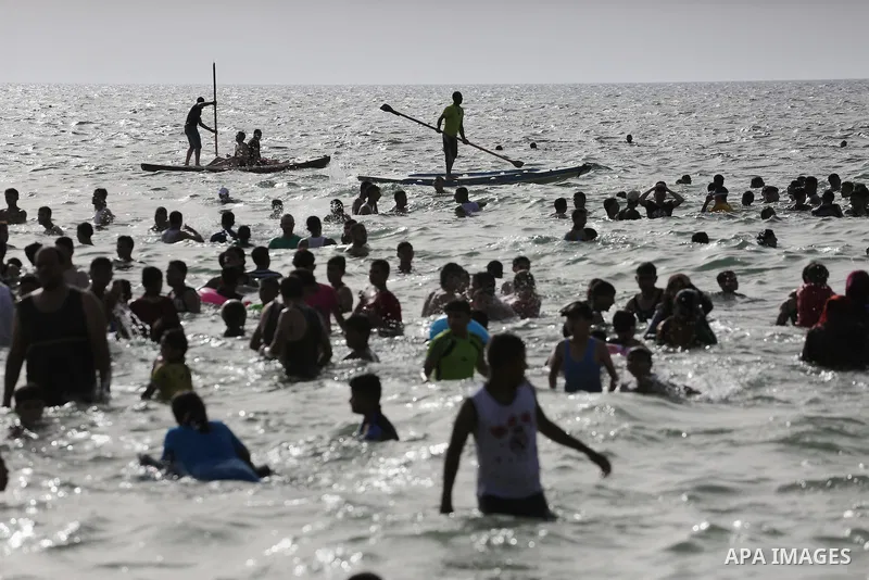 Palestininas swim in the Mediterranean sea on the coast of Gaza city, on June 03, 2016 on the last Friday before the Islamic holy month of Ramadan. Photo by Mohammed Asad
