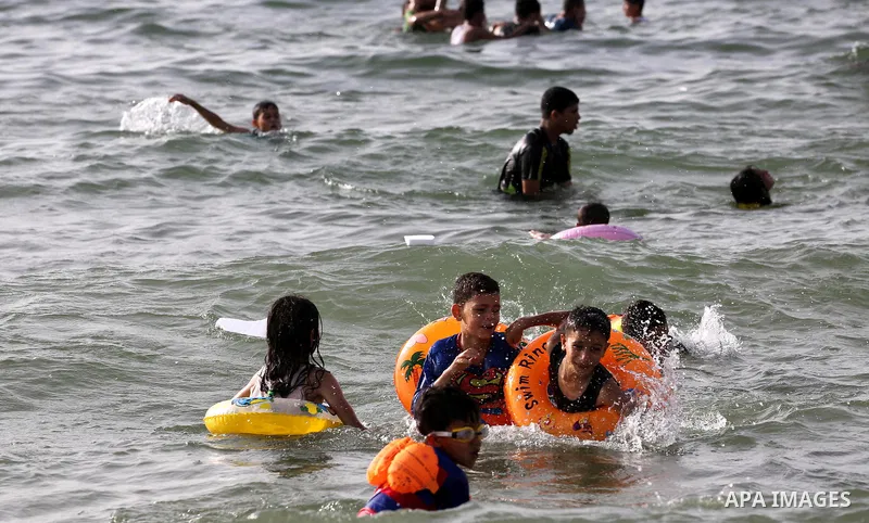 Palestininas swim in the Mediterranean sea on the coast of Gaza city, on June 03, 2016 on the last Friday before the Islamic holy month of Ramadan. Photo by Mohammed Asad