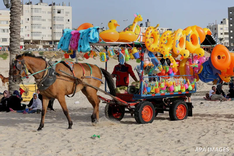 Palestinians enjoy a day at the beach of the Mediterranean sea on the coast of Gaza city, on June 03, 2016 on the last Friday before the Islamic holy month of Ramadan. Photo by Mohammed Asad