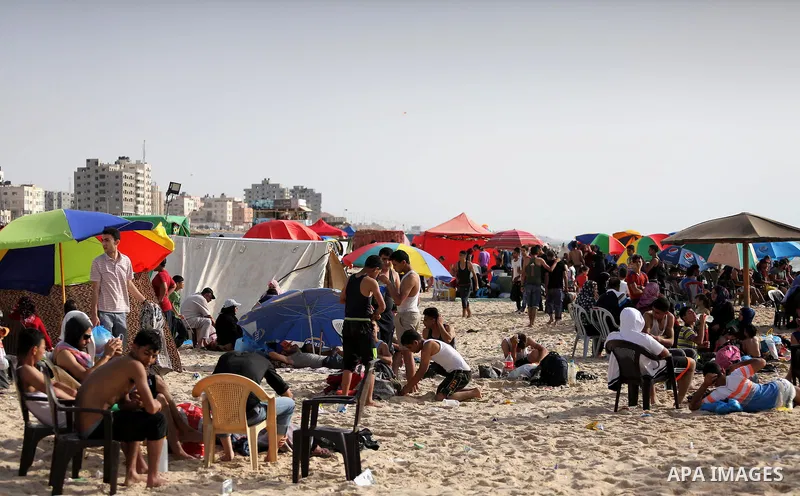 Palestinians enjoy a day at the beach of the Mediterranean sea on the coast of Gaza city, on June 03, 2016 on the last Friday before the Islamic holy month of Ramadan. Photo by Mohammed Asad