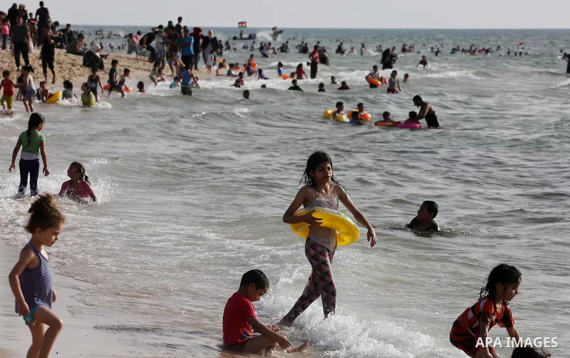 Palestininas swim in the Mediterranean sea on the coast of Gaza city, on June 03, 2016 on the last Friday before the Islamic holy month of Ramadan. Photo by Mohammed Asad